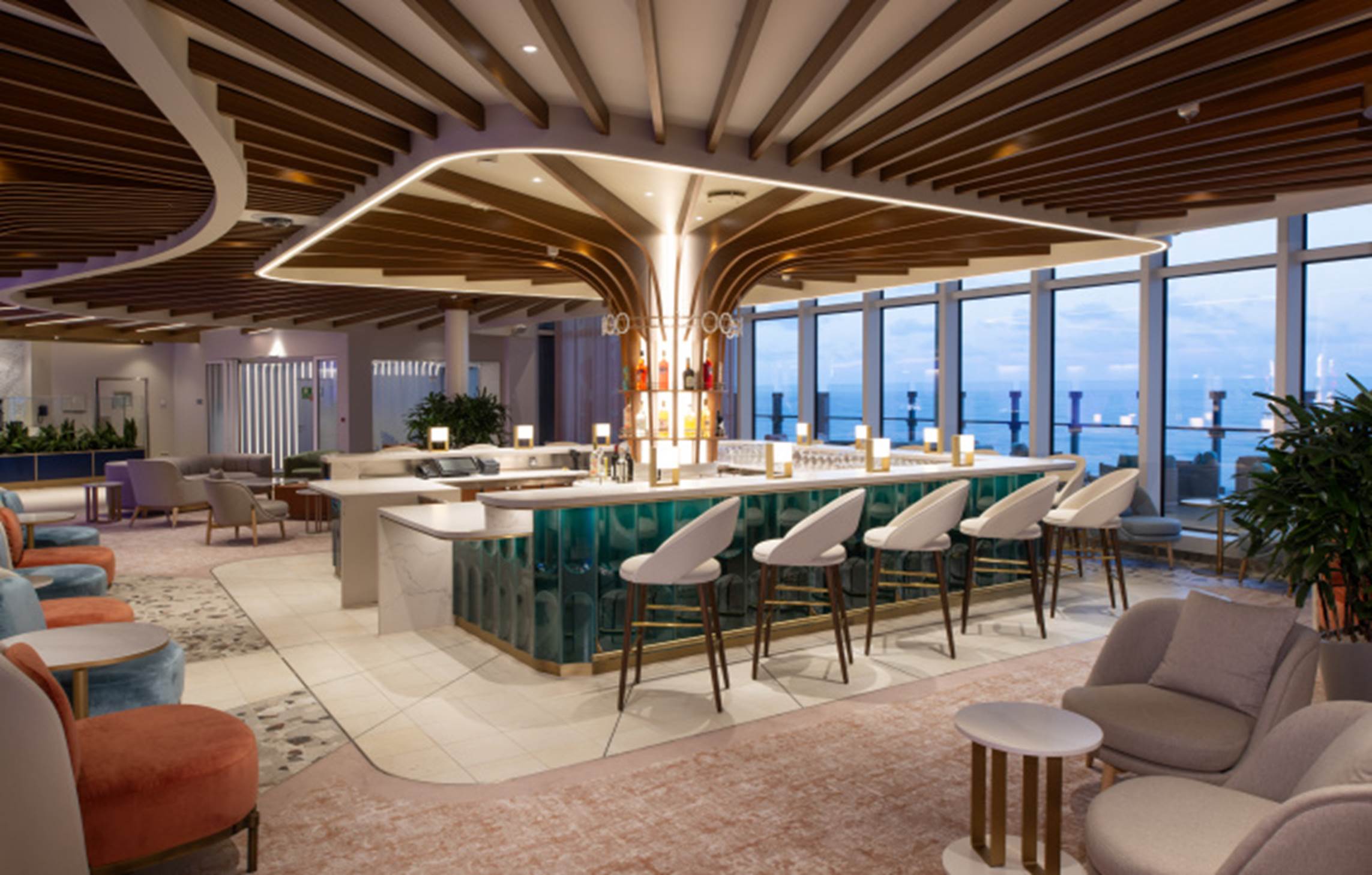A room with a bar and chairs

Description automatically generated