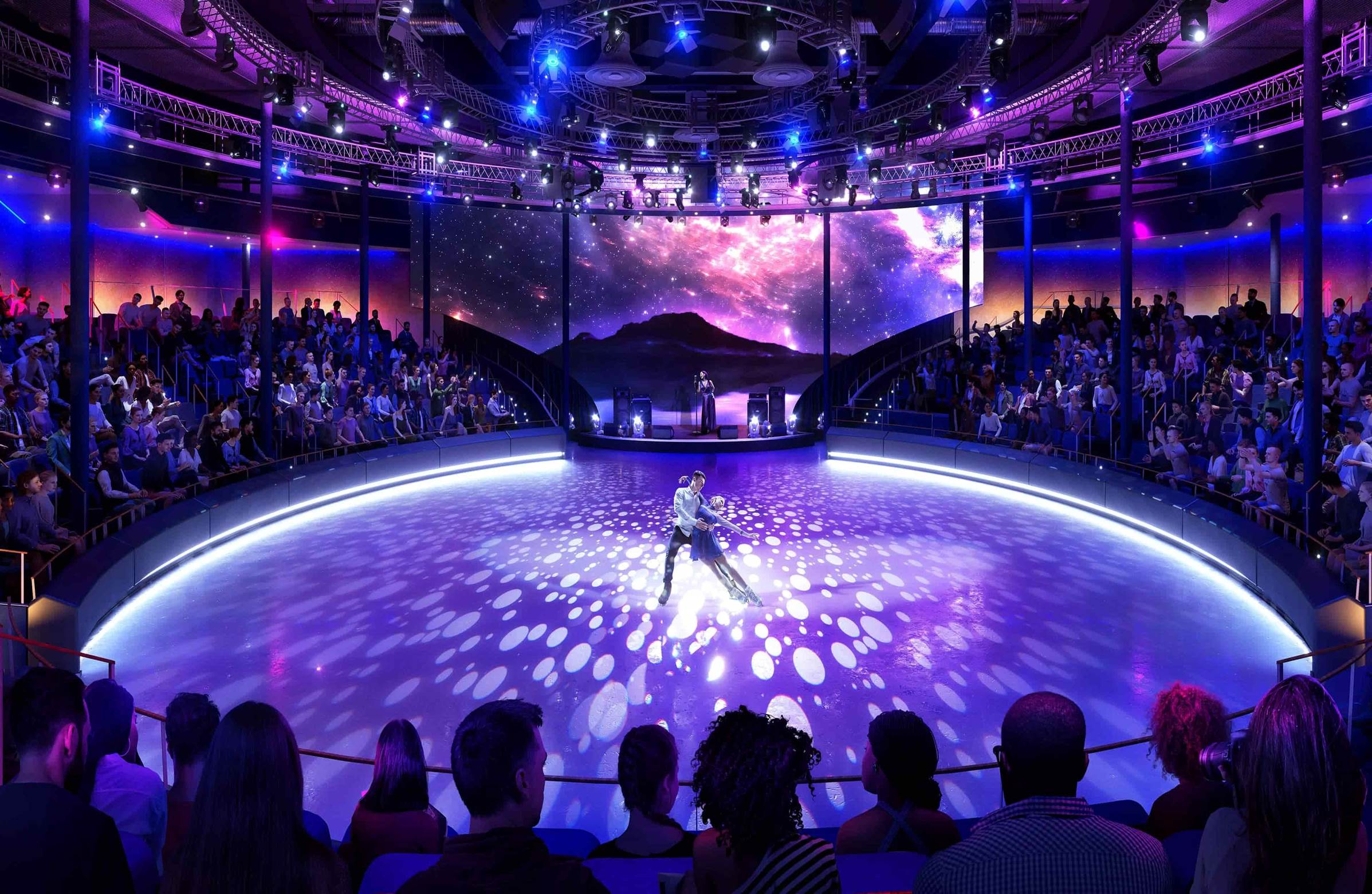A person on a stage with a crowd watching

Description automatically generated