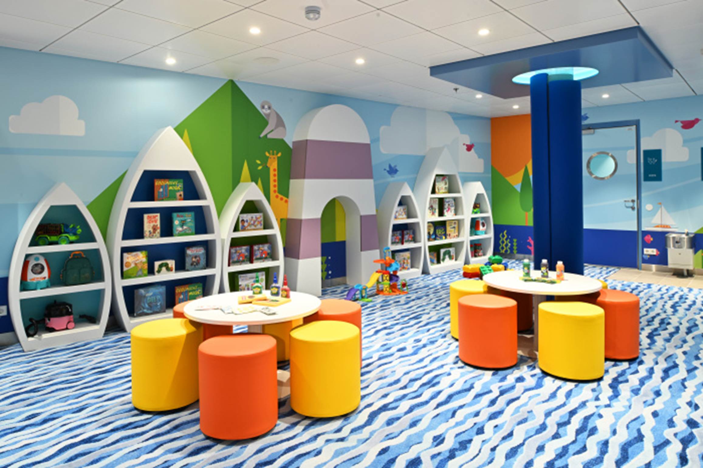 A children's room with colorful tables and shelves

Description automatically generated
