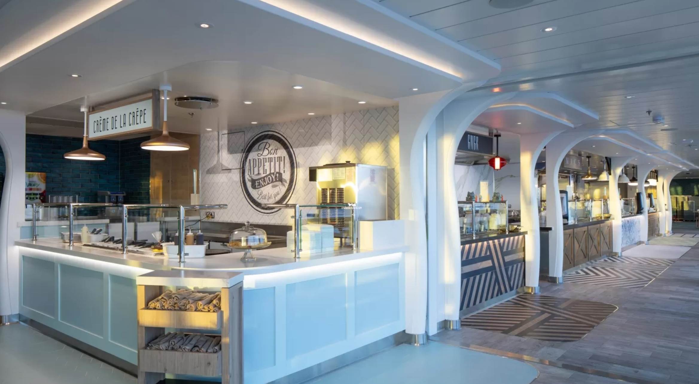 A restaurant with a counter and a few people

Description automatically generated with medium confidence