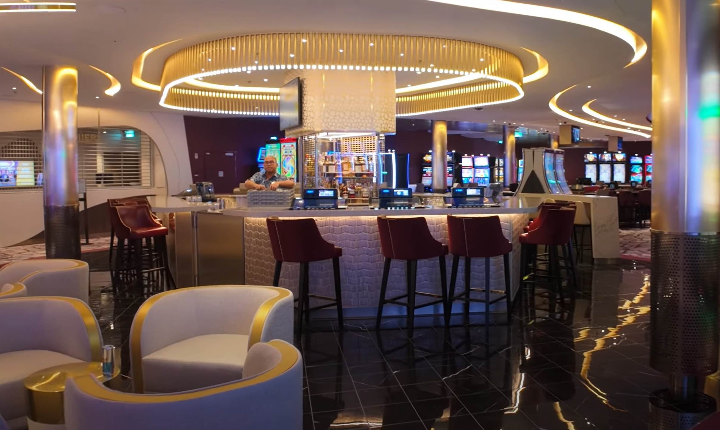 A bar with chairs and a tv

Description automatically generated with medium confidence