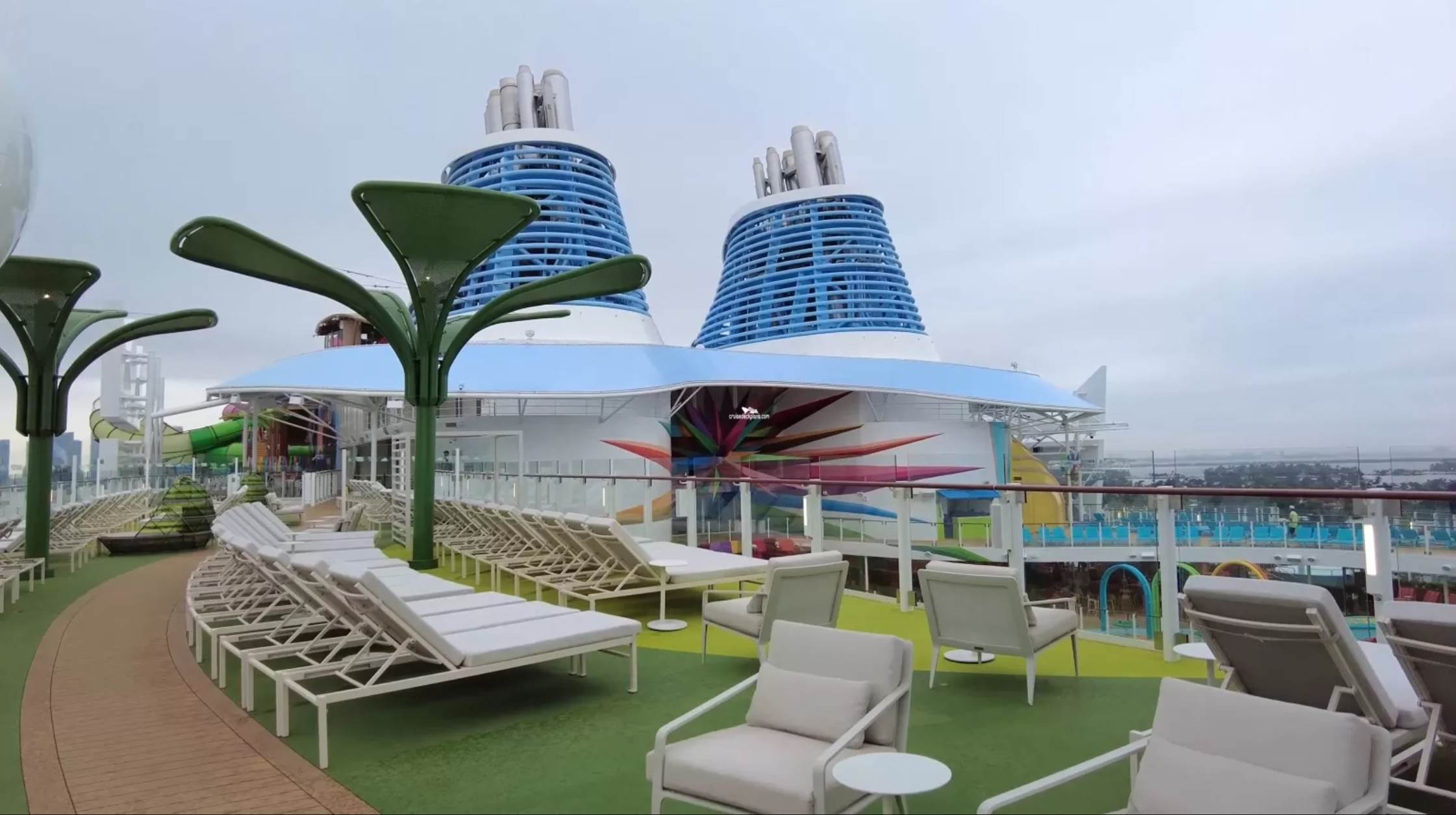 A deck chairs and a cruise ship

Description automatically generated