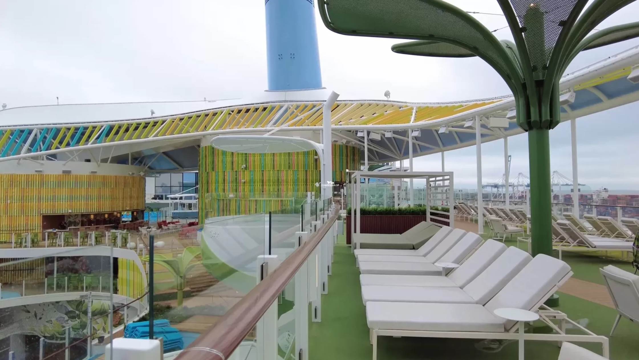 A deck with lounge chairs on a cruise ship

Description automatically generated