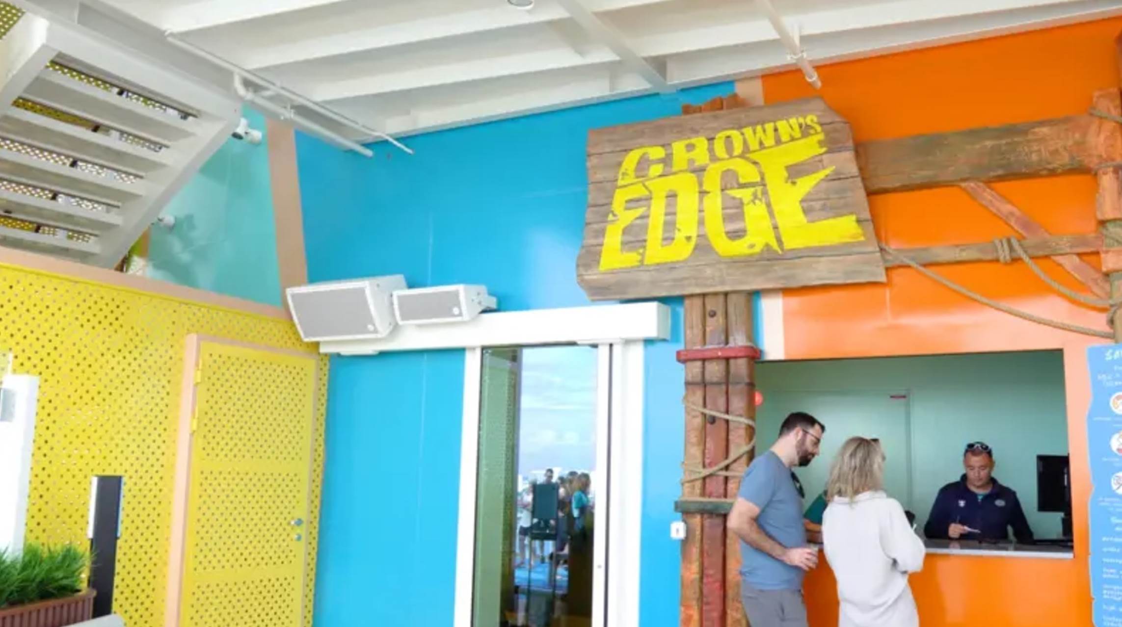 A group of people standing in a room

Description automatically generated