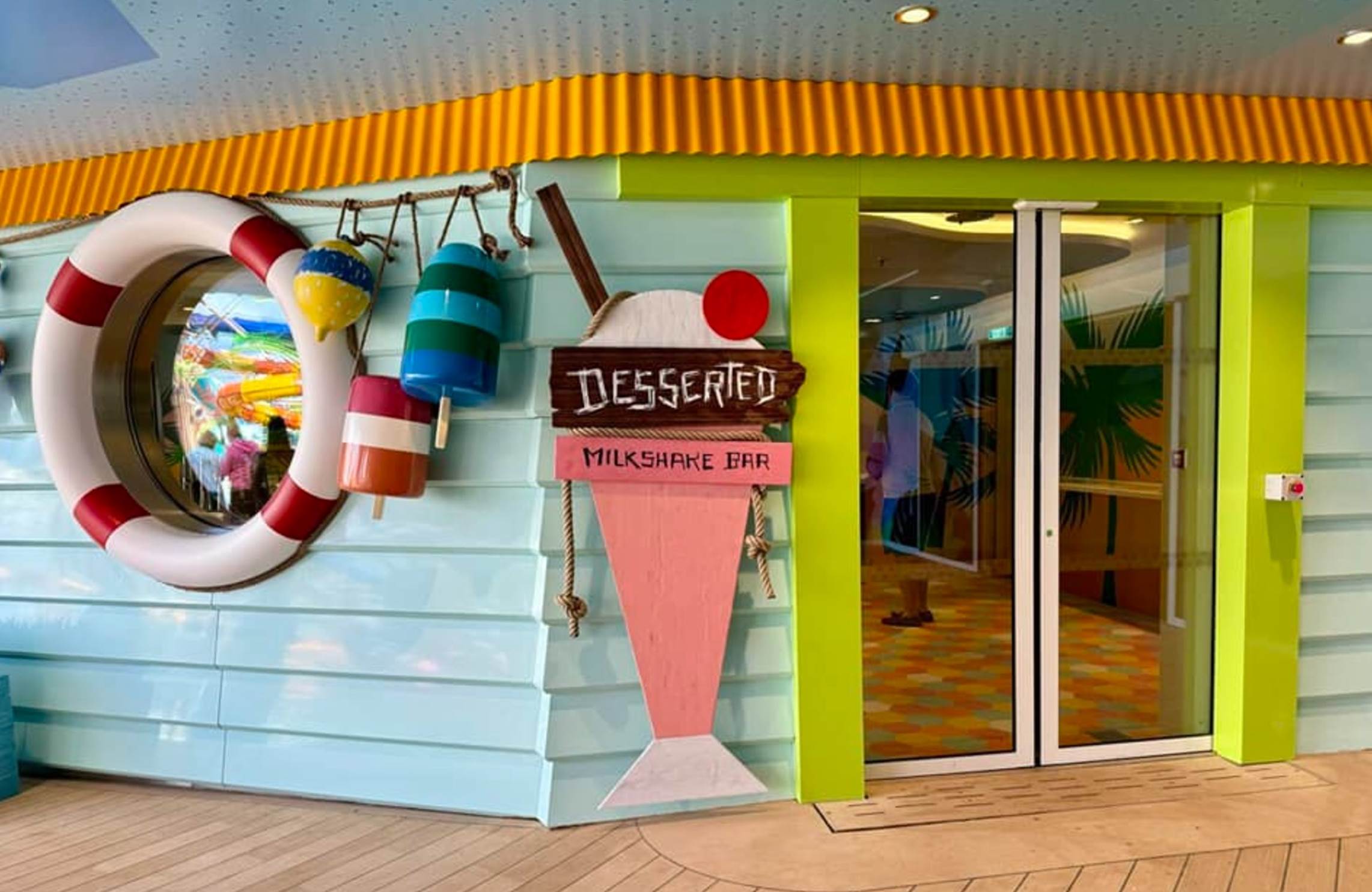 A colorful store front with a sign and a life preserver

Description automatically generated