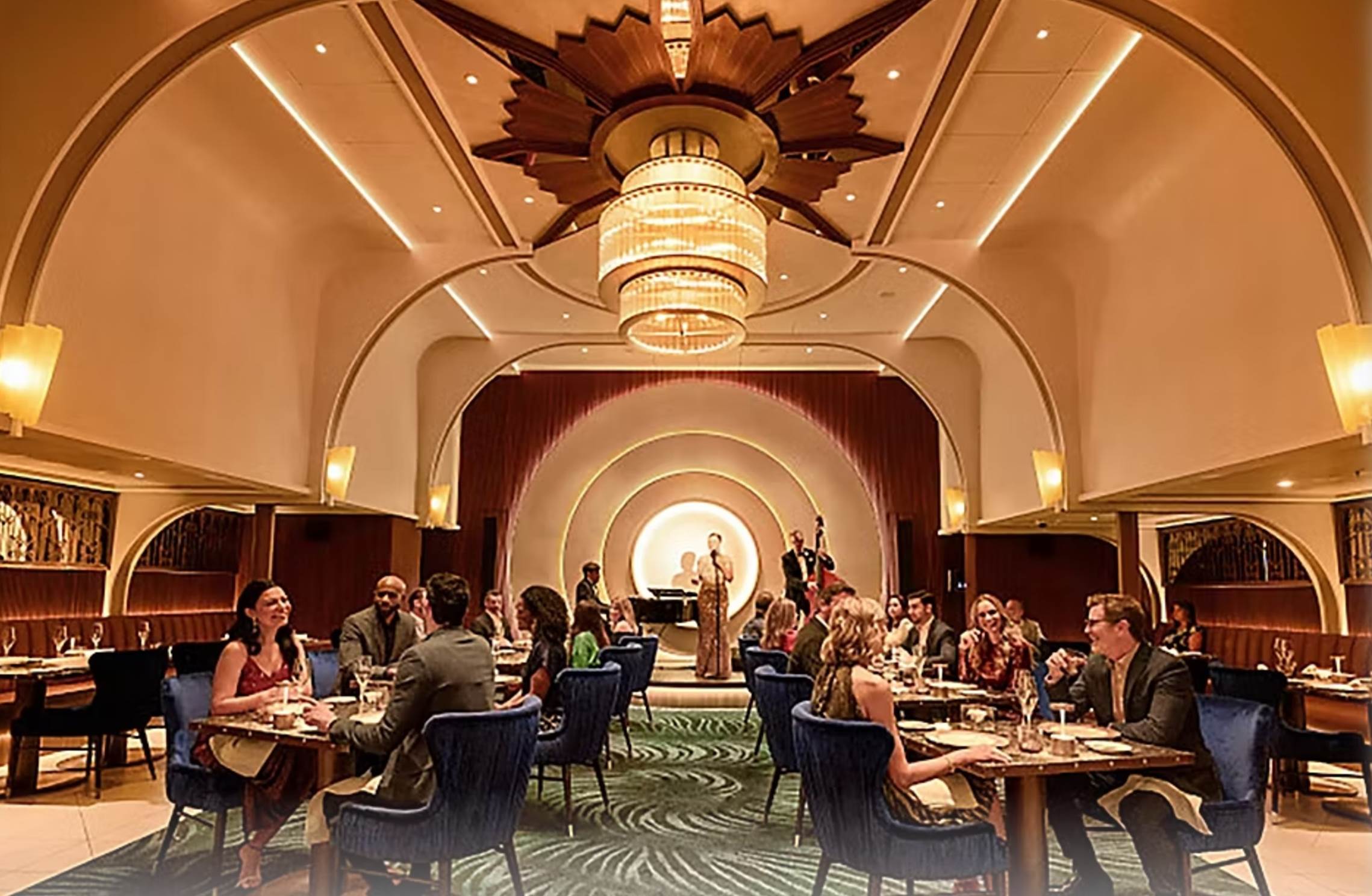 A group of people sitting at tables in a room

Description automatically generated