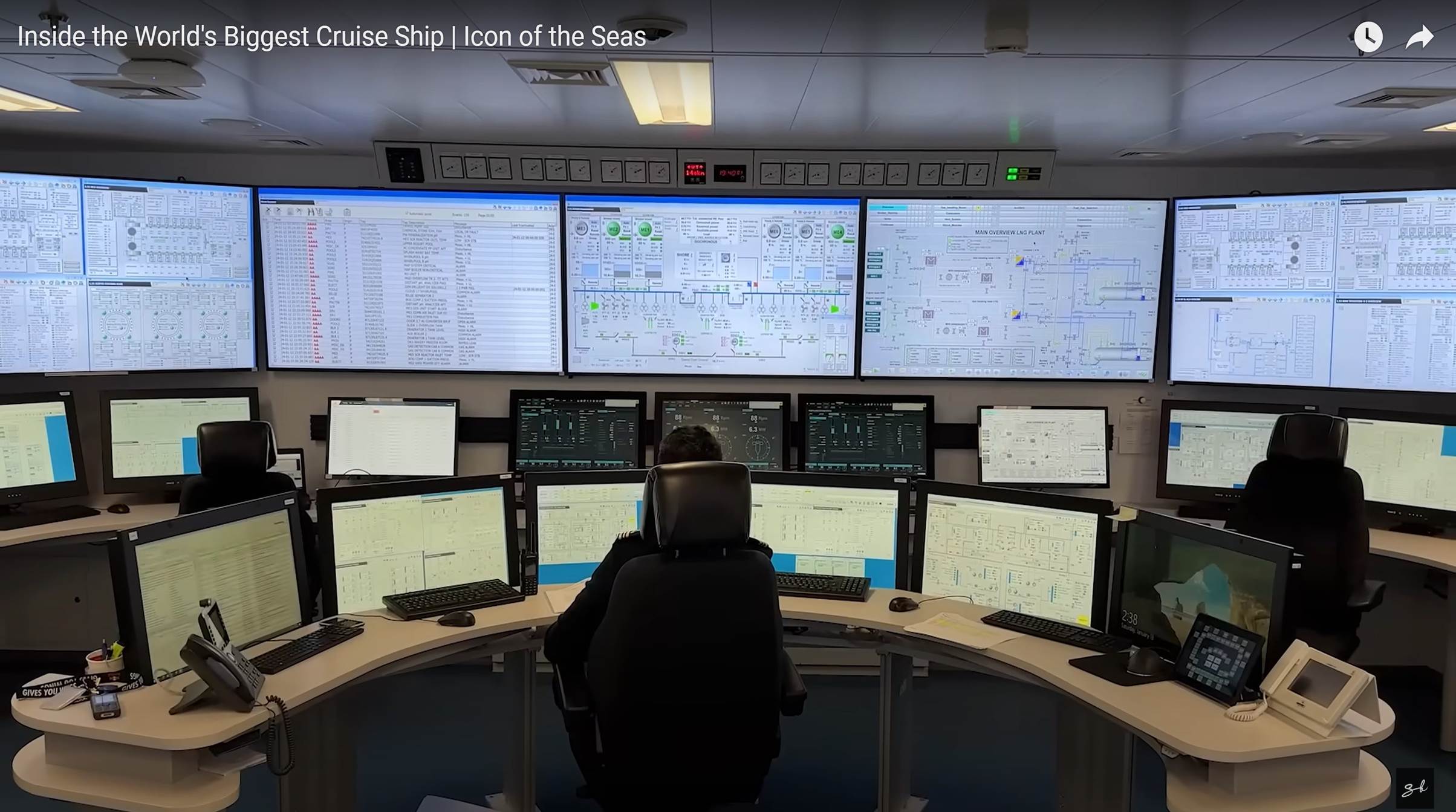 A person sitting in front of a large computer

Description automatically generated