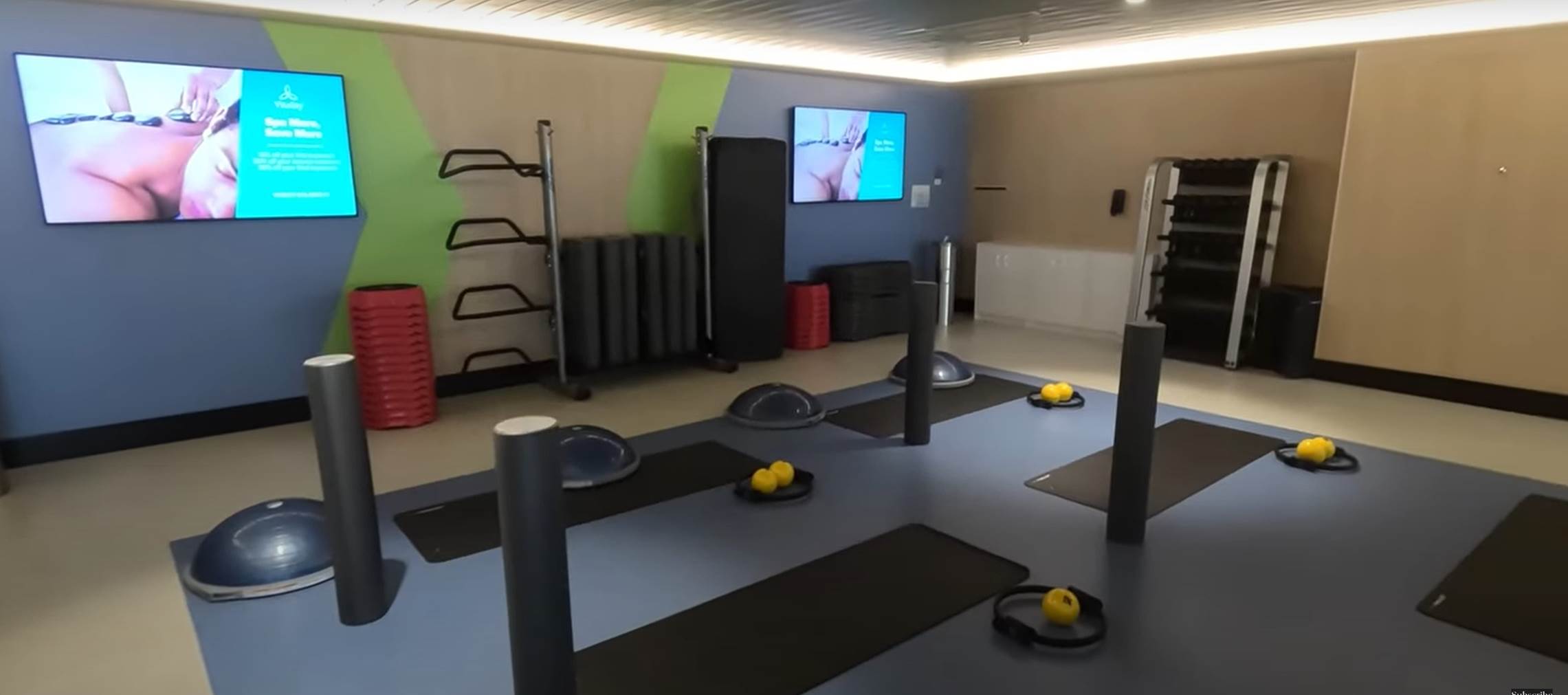 A room with mats and weights

Description automatically generated