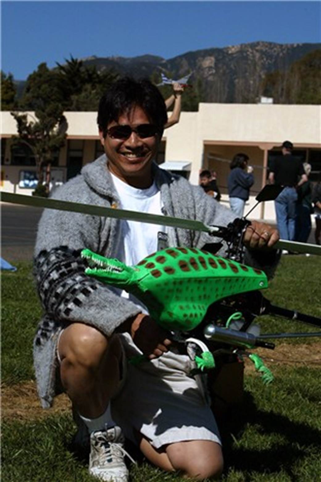 A person holding a toy dinosaur
Description automatically generated